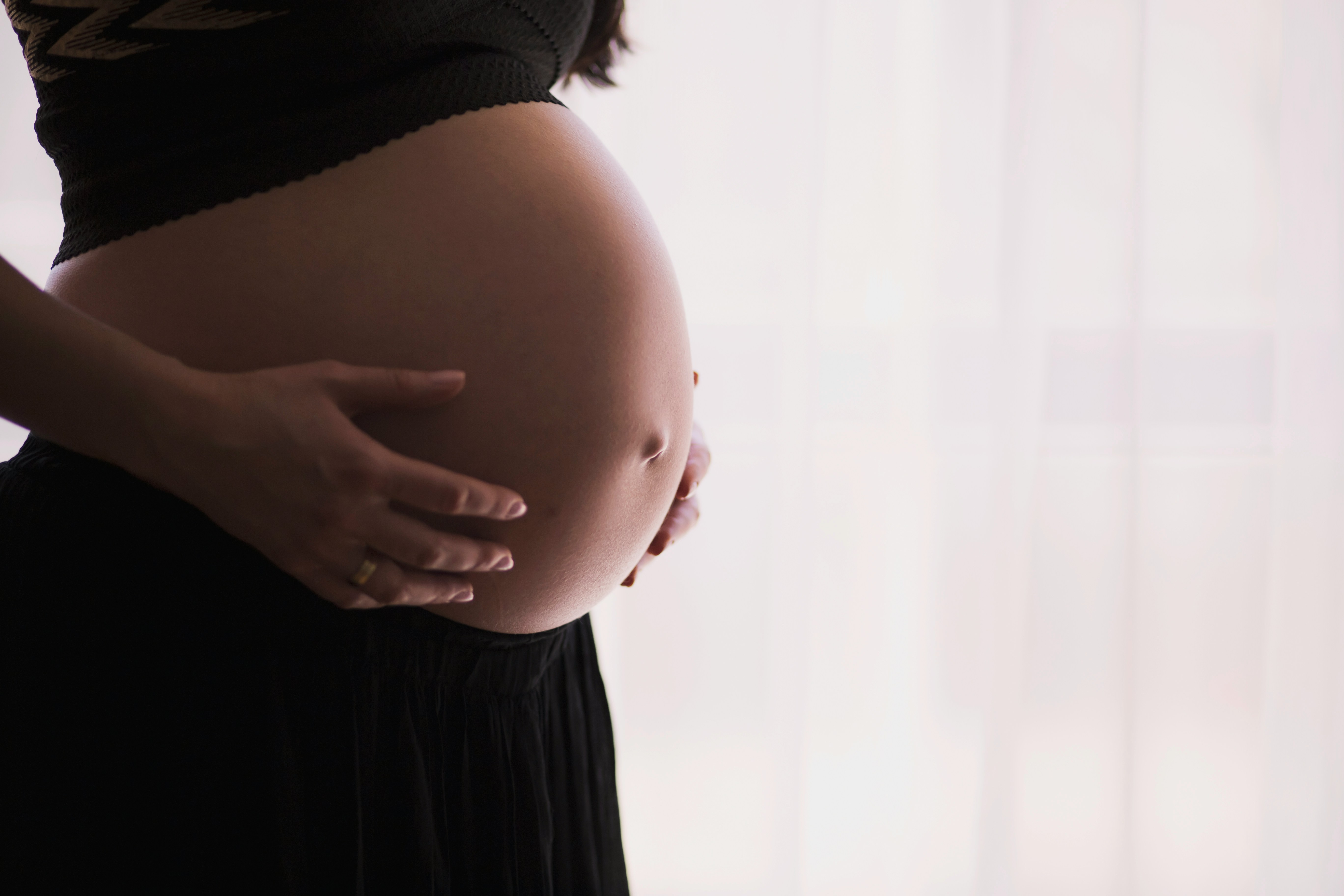 A pregnant woman enjoying a calm moment outdoors